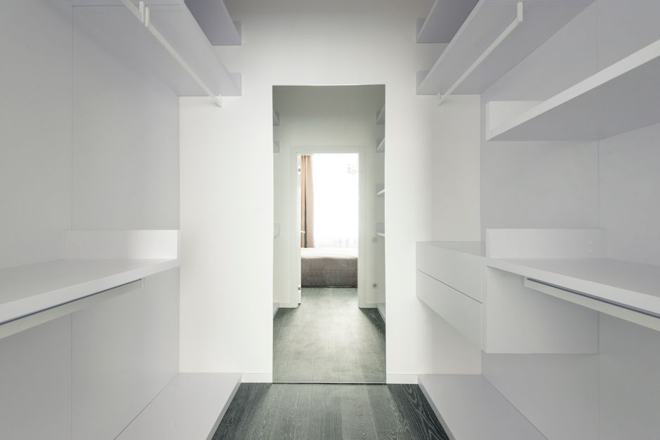 Open closet shelves showcasing organized linens and boxes